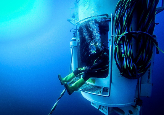 Commercial diver exiting a hyperbaric diving chamber during a subsea operation