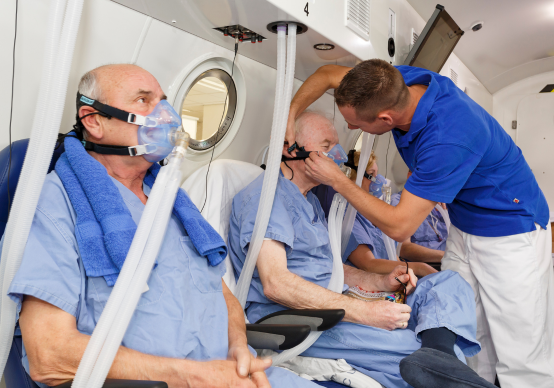 Patients receiving hyperbaric oxygen therapy in a mobile treatment unit